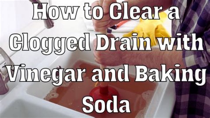 How do you clear a clogged bathroom with baking soda and vinegar?