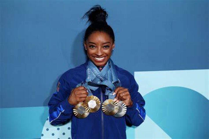 How does Simone Biles get paid?