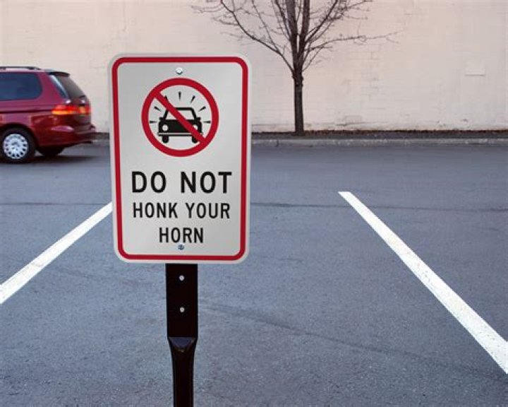 Is it illegal to honk your horn WA?