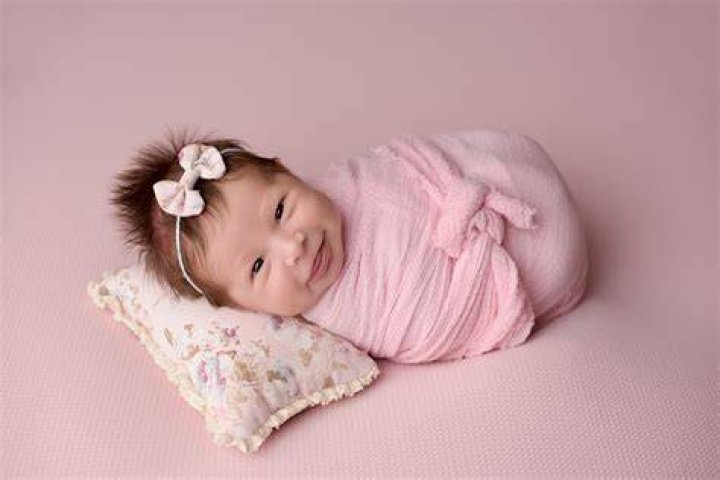 What does a newborn smile mean?