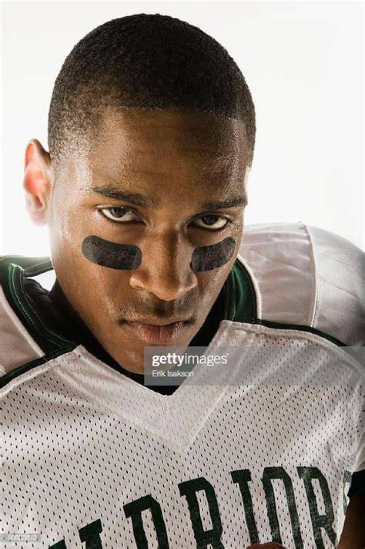 What does the cross on football players face mean?