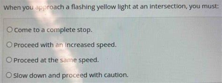 When you approach a flashing yellow light at an intersection you must?